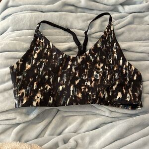 Black and brown sports bra with colorful pattern and adjustable straps